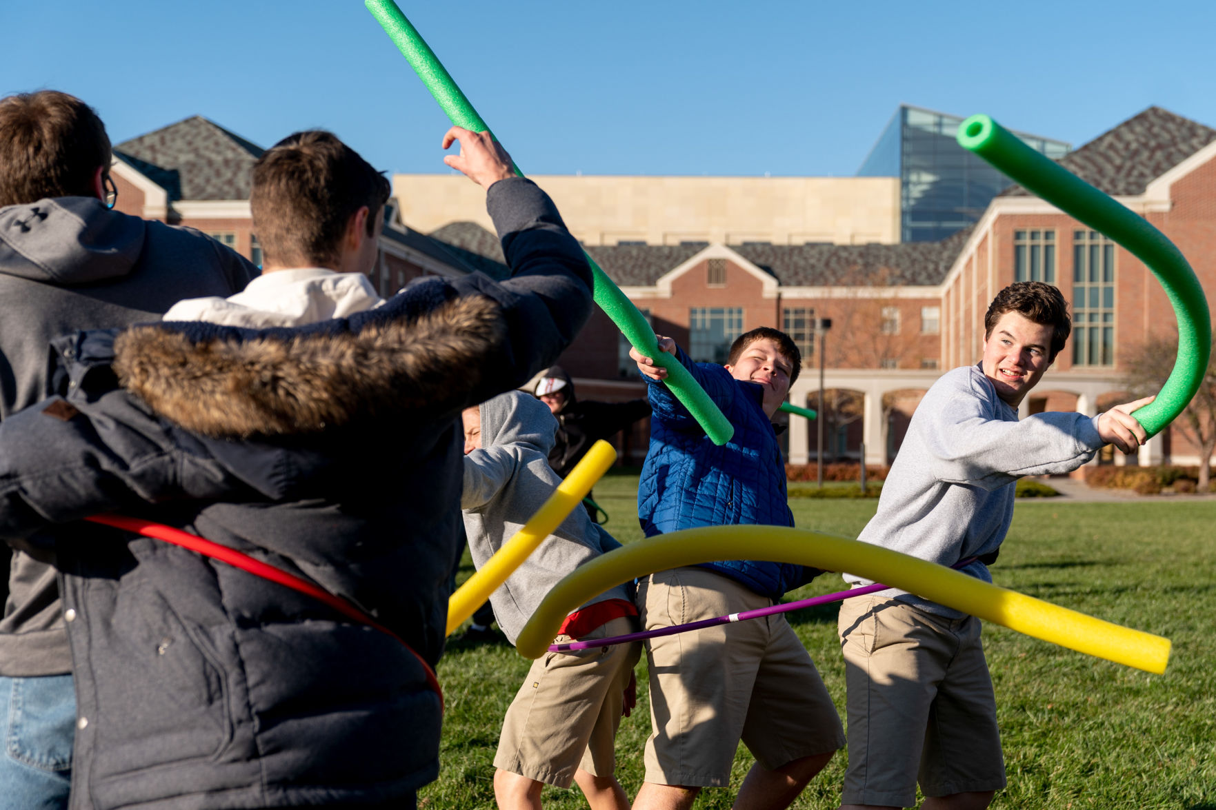 Students hit each other with pool noodles during Battle of Actium reenactment